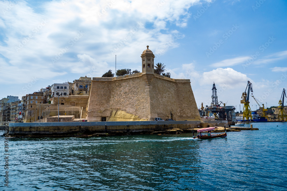 A water taxi passes the Spur bastion at the tip of city of Senglea in Malta.