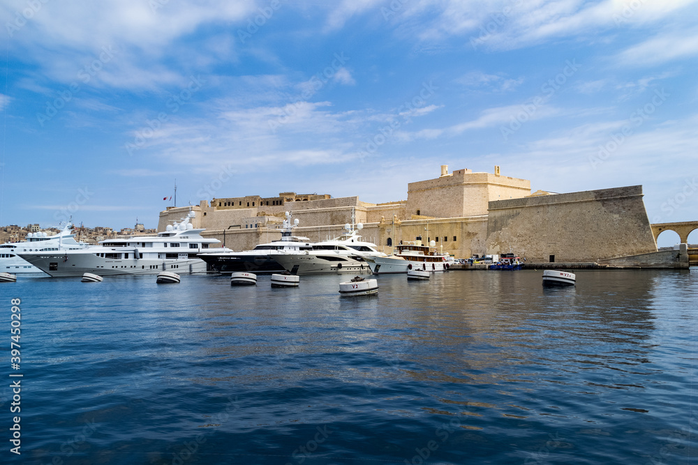Super Yachts moored in Dockyard Creek in front of Fort St Angelo, Birgu (Vittoriosa), Malta.