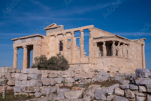 The Erechtheion or Erechtheum, an ancient Greek temple on north side of the Acropolis of Athens in Greece, dedicated to Athena and Poseidon, Greek Gods, overlooking Athens, Greece.