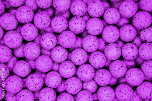 Small, sweet purple balls. Round boilies used as carp fishing bait. photo