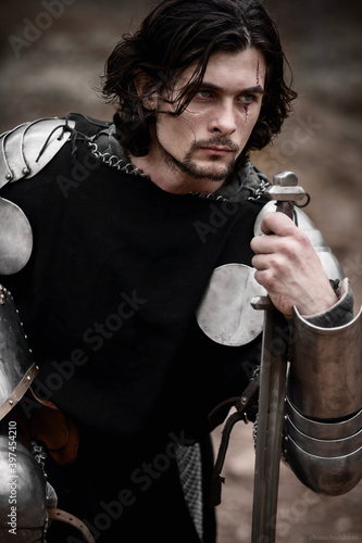 Knight in armor and with a sword. Medieval warrior