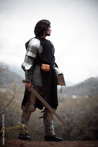 Fotografiet Knight in armor and with a sword. Medieval warrior