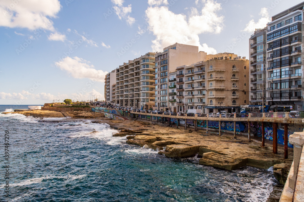 Foto de The rocky beach at QuiSiSana, Sliema, Malta. The man made