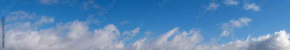 Blue sky with clouds, wide cloudscape background panorama