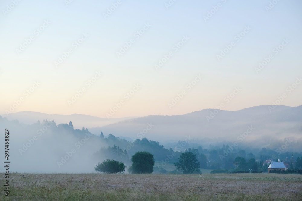 Beautiful misty morning landscape fo Krempna village in Low Beskid Mountains, Poland Beautiful misty morning landscape fo Krempna village in Low Beskid Mountains, Poland