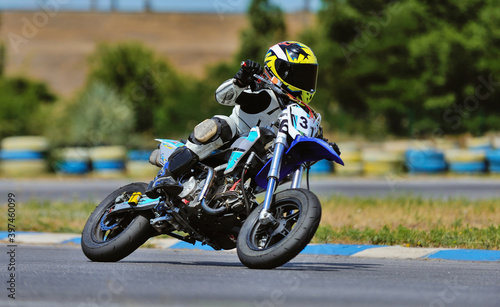 Motorcycle practice leaning into a fast corner on track