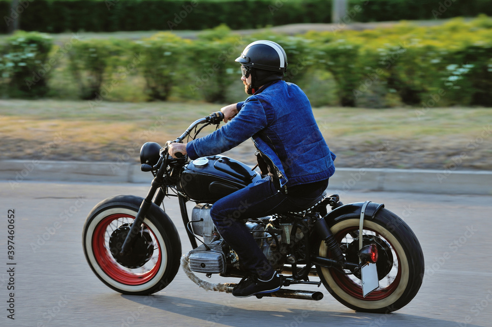 A view of a young man riding a motorcycle on an open road