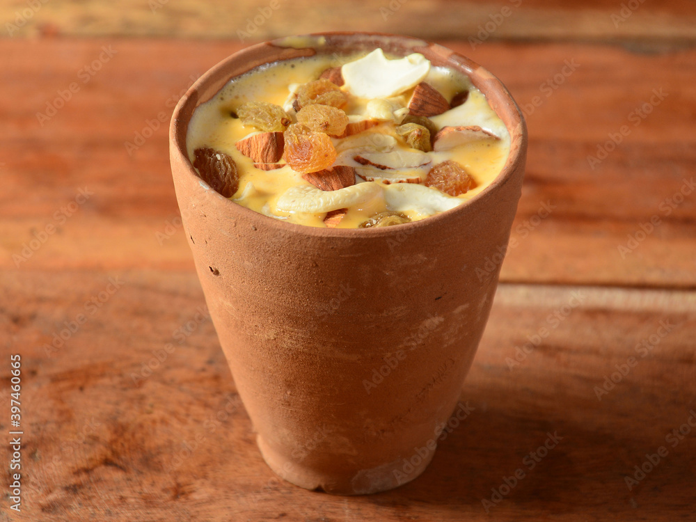 Matka malai kulfi or clay pot malai kulfi is a indian traditional ice cream, Rich in taste and creamier,The malai flavoured ice cream set to be frozen in clay pot, that is called as matka malai kulfi - obrazy, fototapety, plakaty 