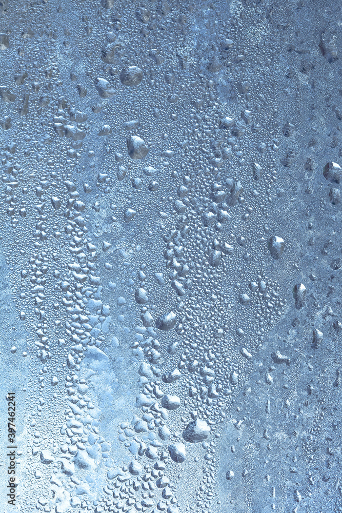 The texture of frozen drops of condensation on a transparent glass window. Water drops. Rain. Abstract texture background. A sharp cold snap, a frozen drop of water on the glass in winter The texture of frozen drops of condensation on a transparent glass window. Water drops. Rain. Abstract texture background. A sharp cold snap, a frozen drop of water on the glass in winter