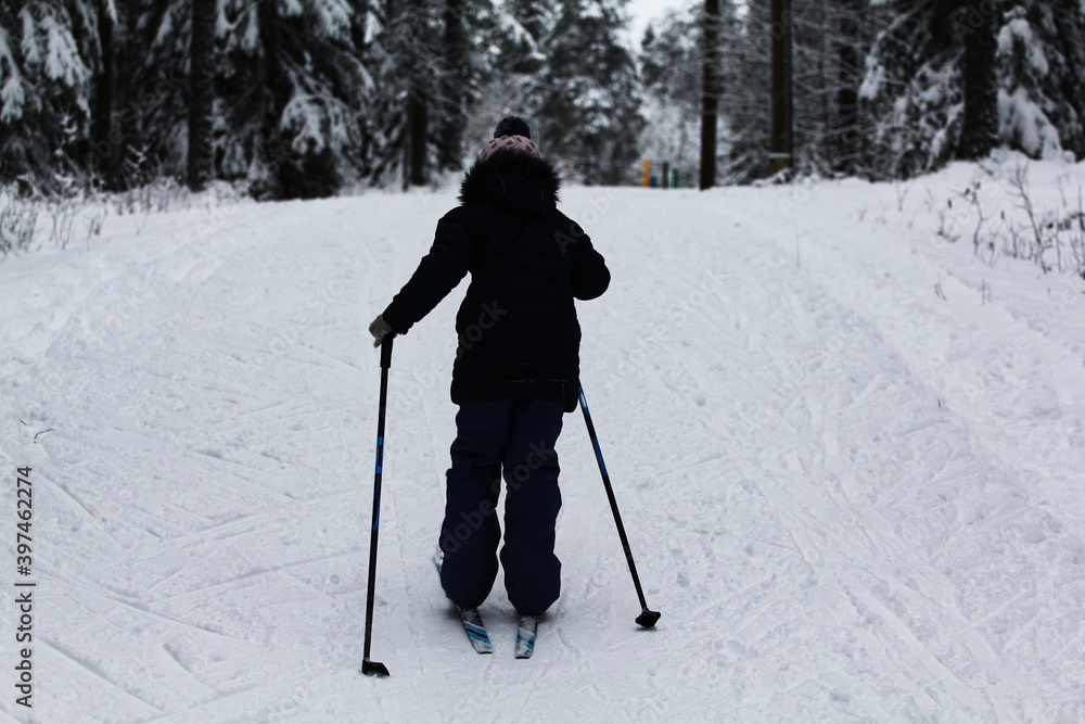 little girl skiing in the winter forest little girl skiing in the winter forest