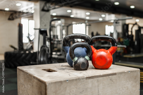 Functional training equipment. Kettlebells on a wooden box in modern gym