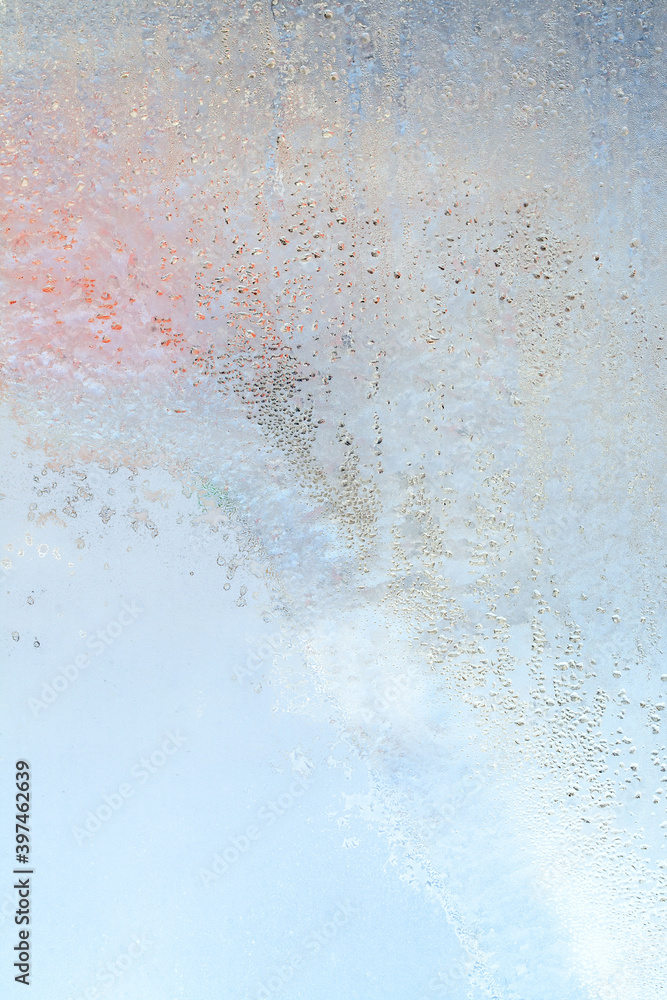 The texture of frozen drops of condensation on a transparent glass window. Water drops. Rain. Abstract texture background. A sharp cold snap, a frozen drop of water on the glass in winter The texture of frozen drops of condensation on a transparent glass window. Water drops. Rain. Abstract texture background. A sharp cold snap, a frozen drop of water on the glass in winter