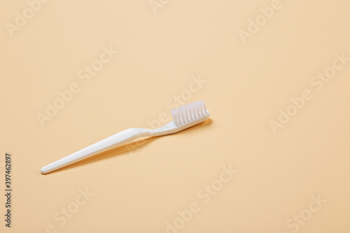 white toothbrush on beige background