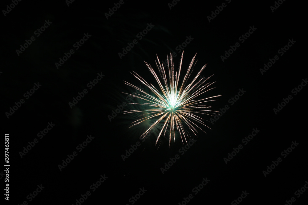 Single bright green and white, alone in upper right, firework isolated on black, bright colorful, copy space.