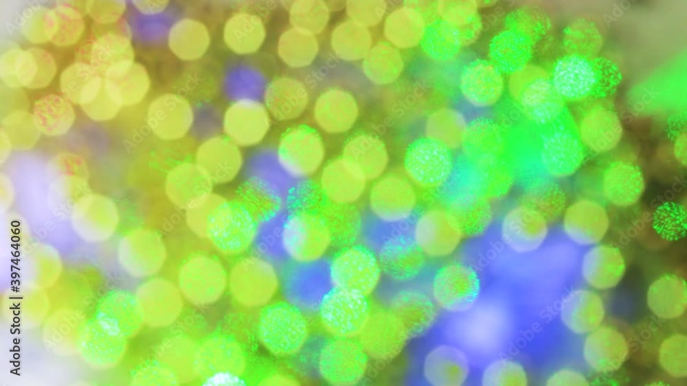 Christmas golden lights and green beam create beautiful bokeh. The glow of the blinking garland is blurred. Animated, festive, decorative background. New Year's celebration. Christmas golden lights and green beam create beautiful bokeh. The glow of the blinking garland is blurred. Animated, festive, decorative background. New Year's celebration.