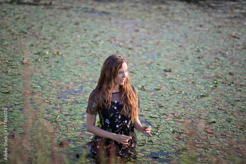 beautiful girl bathes in a swamp, a mermaid in a swamp. photo