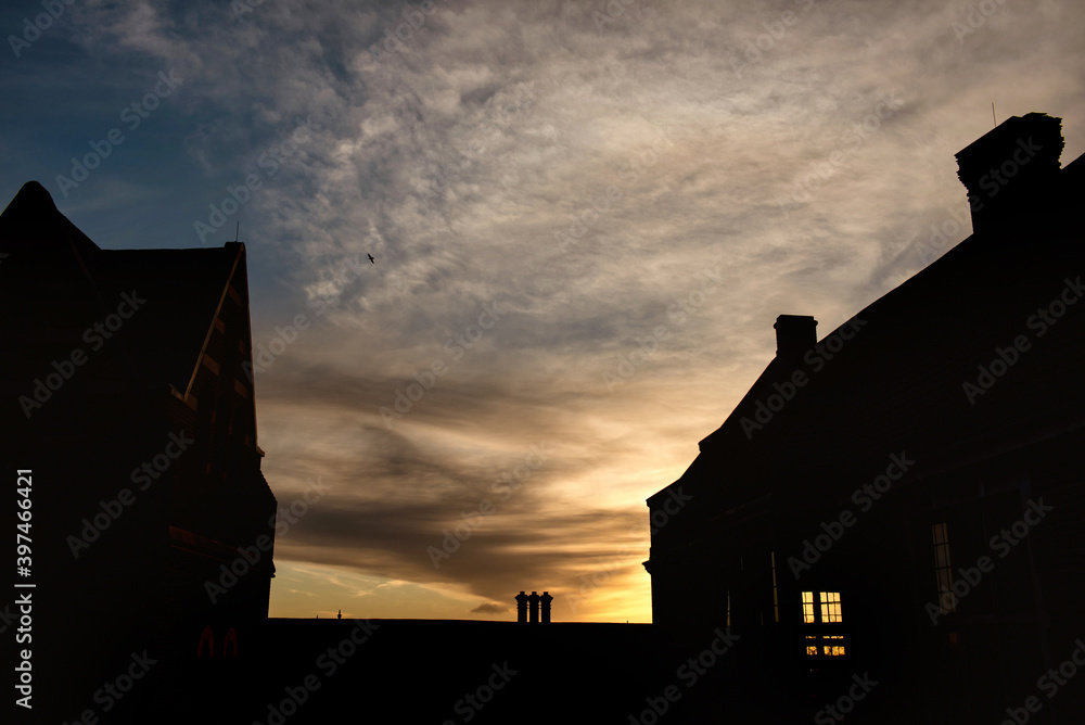 Sunrise in Harrow on the hill with a warm light going through the window of Harrow School building, England 
