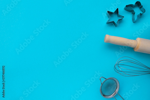 Different baking tools on blue background, top view. Baking and cooking concept