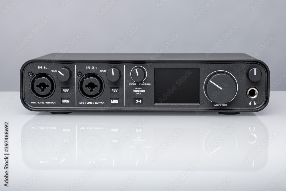 Fototapeta premium USB Audio interface for home recording or Mixing, external sound card black on white glass with reflection.