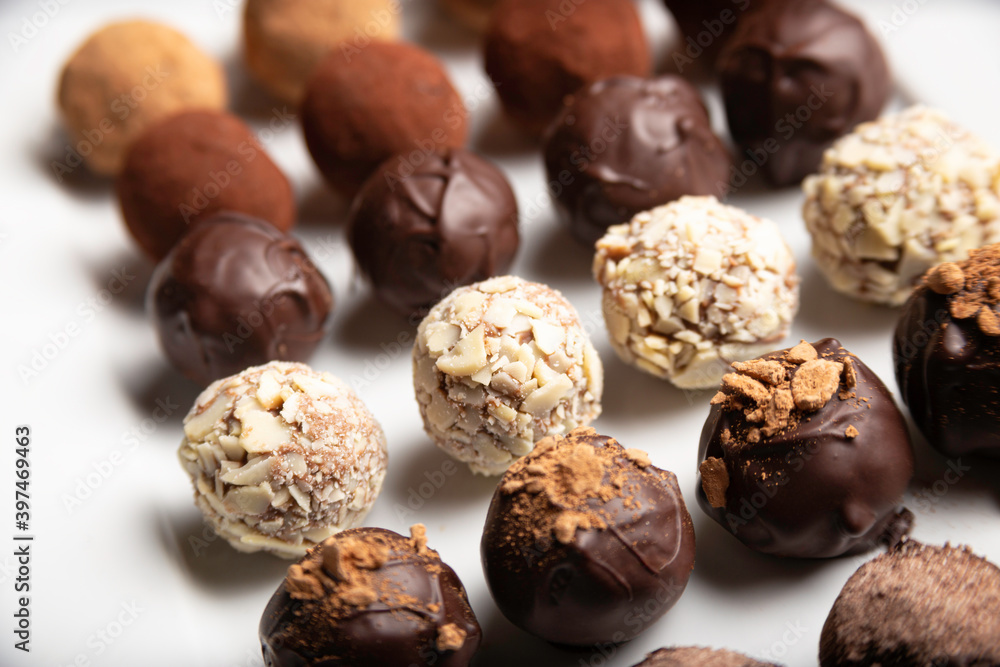 variety of handmade gourmet chocolate truffle candy on a white plate variety of handmade gourmet chocolate truffle candy on a white plate