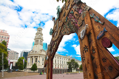 Waharoa gate inspired by Maori and Polynesian influences in Aotea Square, with Auckland Town Hall in the background. The Town Hall is a Edwardian building, Queen Street, Auckland CBD, New Zealand.
