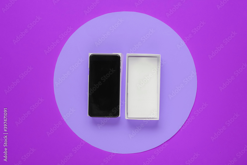 New modern smartphone in box on pink background with purple circle in the middle. Minimalistic fashion concept, gift New modern smartphone in box on pink background with purple circle in the middle. Minimalistic fashion concept, gift