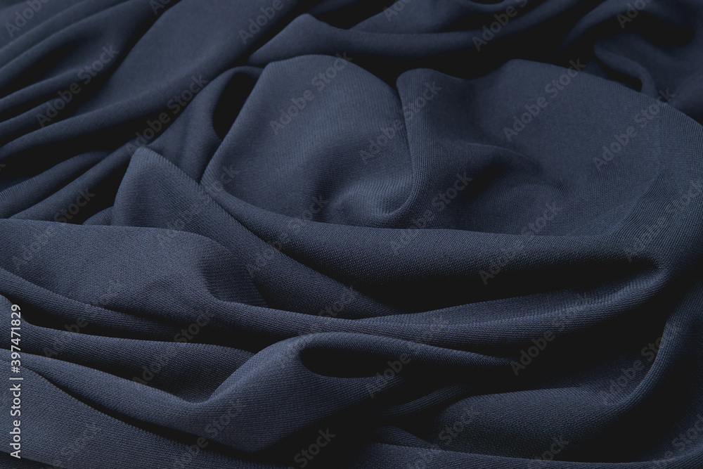 Black cloth is randomly spread on the table. Dark material with fine texture and slight sheen. Background for textile and industrial design direction. Black cloth is randomly spread on the table. Dark material with fine texture and slight sheen. Background for textile and industrial design direction.