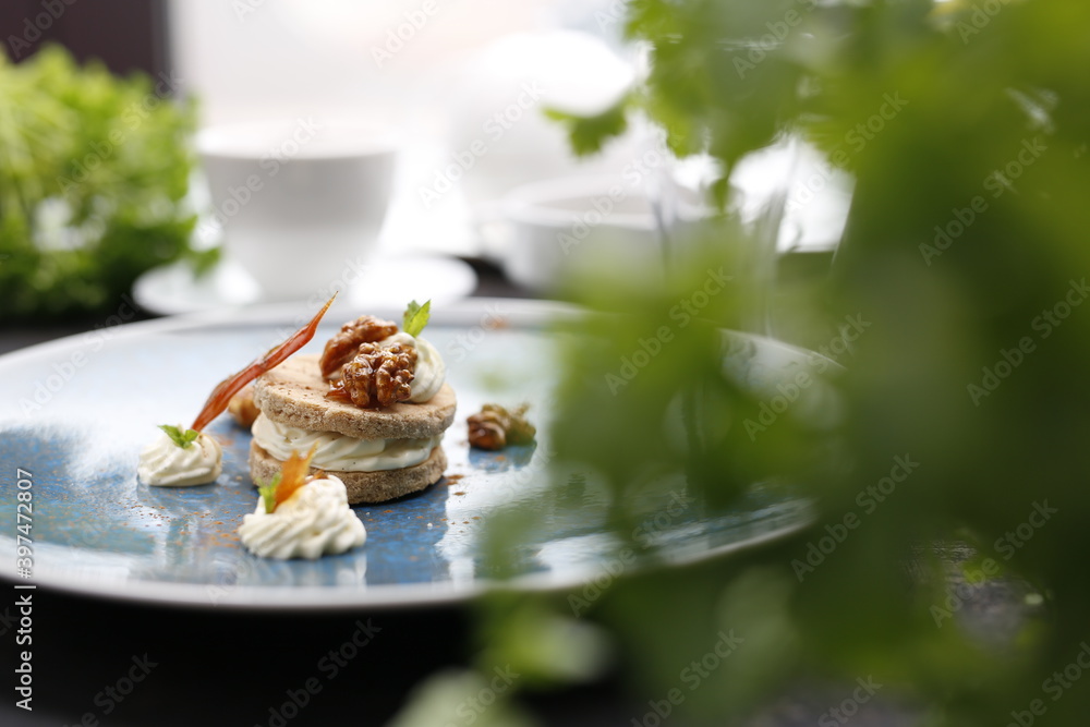 Sweet dessert. Peanut cookie with mascarpone cream.
Food, a tasty dish served on a plate. A proposal for an application. Culinary photography.