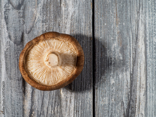 Shiitake mushrooms on wooden background.