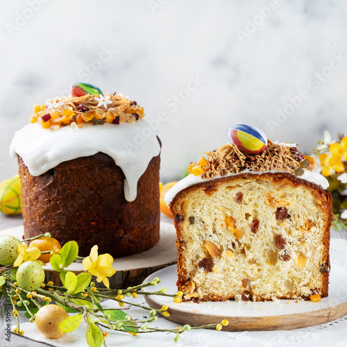 Easter orthodox sweet bread, kulich and colorful quail eggs. Holidays breakfast concept with copy space.