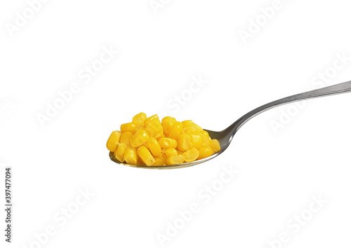 tablespoon with canned corn on white background