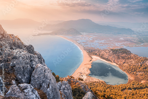 Scenic aerial paniramic view from mountain Bozburun to Iztuzu beach and the Dalyan river Delta as well as lake Sulungur at sunset time. Majestic autumn landscape. Explore natural wonders of Turkey photo