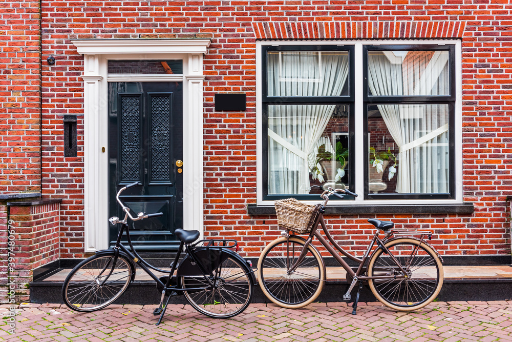 Dutch village green houses facade and bicycle. Dutch village green houses facade and bicycle.