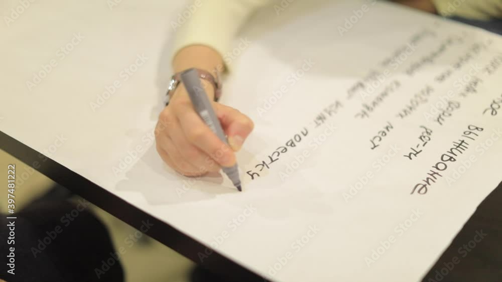 girl writes at the event with a pencil marker on a sheet girl writes at the event with a pencil marker on a sheet