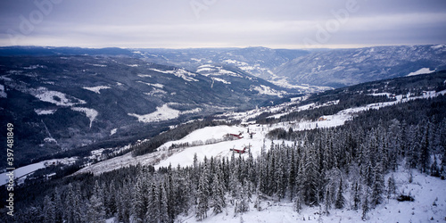 Flying over winter wonderland with frozen creeks and snow clothed trees. Shot with a drone in Hallingdal, Gol. 