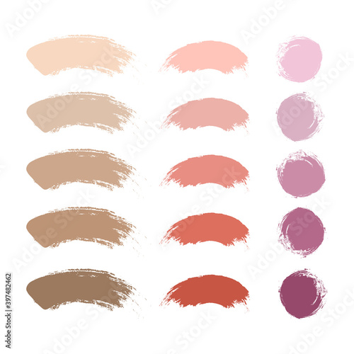 Makeup stroke brushes, nude lipstick, blush and foundation or powder swatches