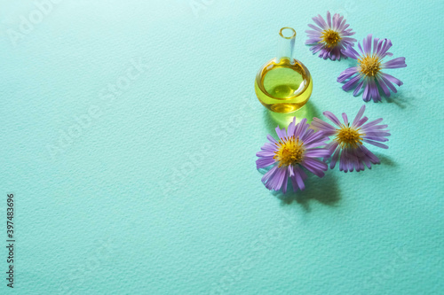 Flower oil on a blue background. Place for your text.