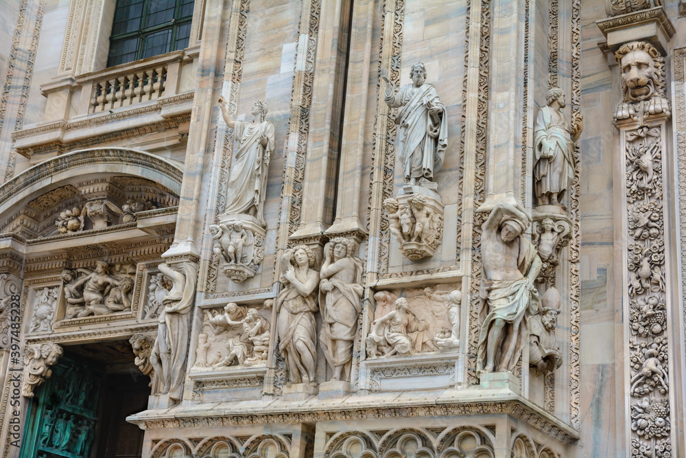 Sculptures at the main entrance to Milan Cathedral. Duomo Cathedral. Italy.
