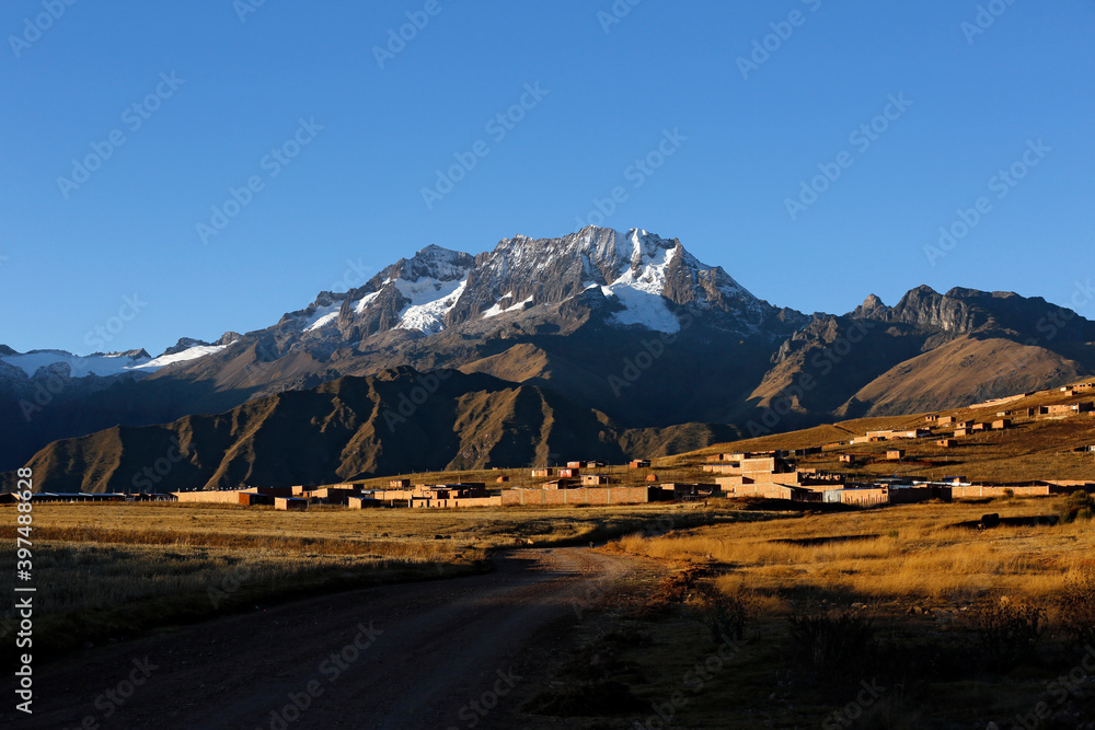Mount Chicon Behind a Highland Village, Under a Blue Sky. Urubamba Mountain Range, Cusco Region, Peru
