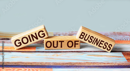 Text Going out of Business written on wooden blocks and colorful background