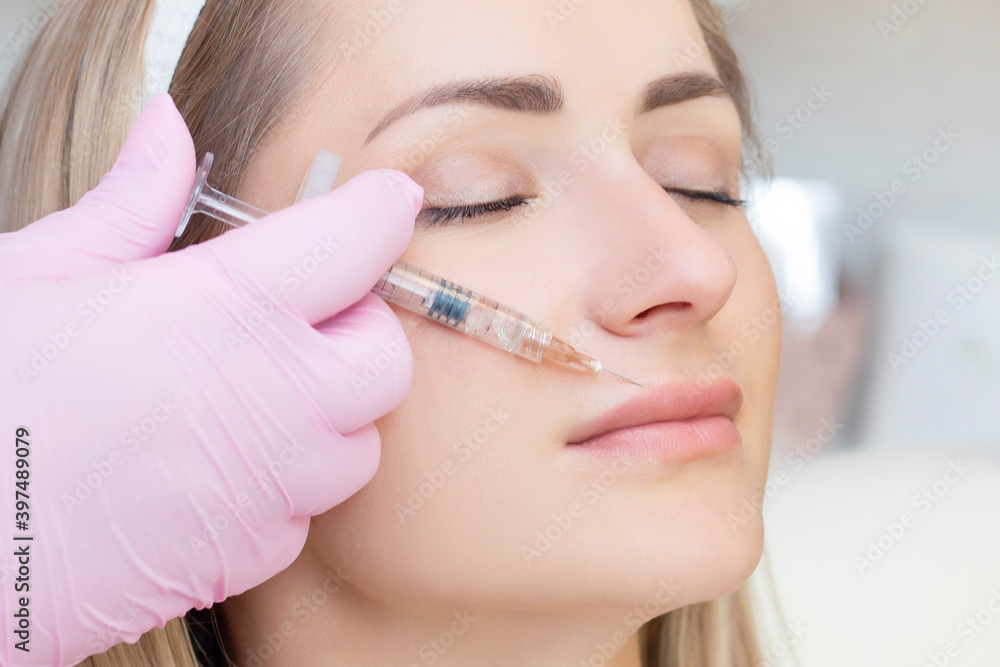 young woman receiving cosmetic injection. Woman in a beauty salon. Plastic Surgery Clinic. young woman receiving cosmetic injection. Woman in a beauty salon. Plastic Surgery Clinic.