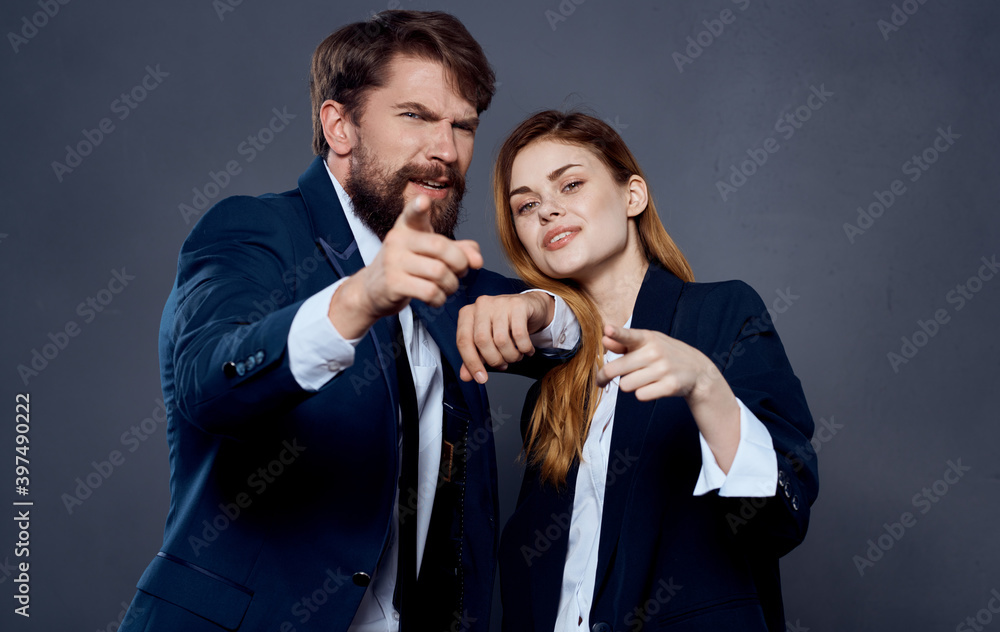 Business man and woman in suit gesturing with hands on gray background cropped view Business man and woman in suit gesturing with hands on gray background cropped view