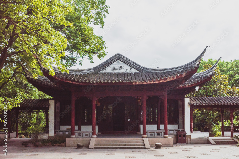 Traditional Chinese architecture among trees on Tiger Hill (Huqiu), Suzhou, Jiangsu, China