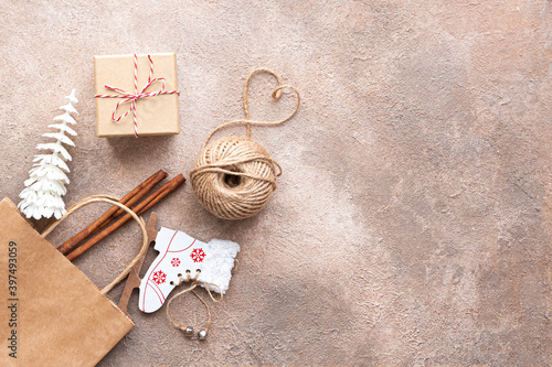 Zero waste and eco christmas concept. ball of twine, gift box, craft paper, fir tree and ski on beige brown background. 