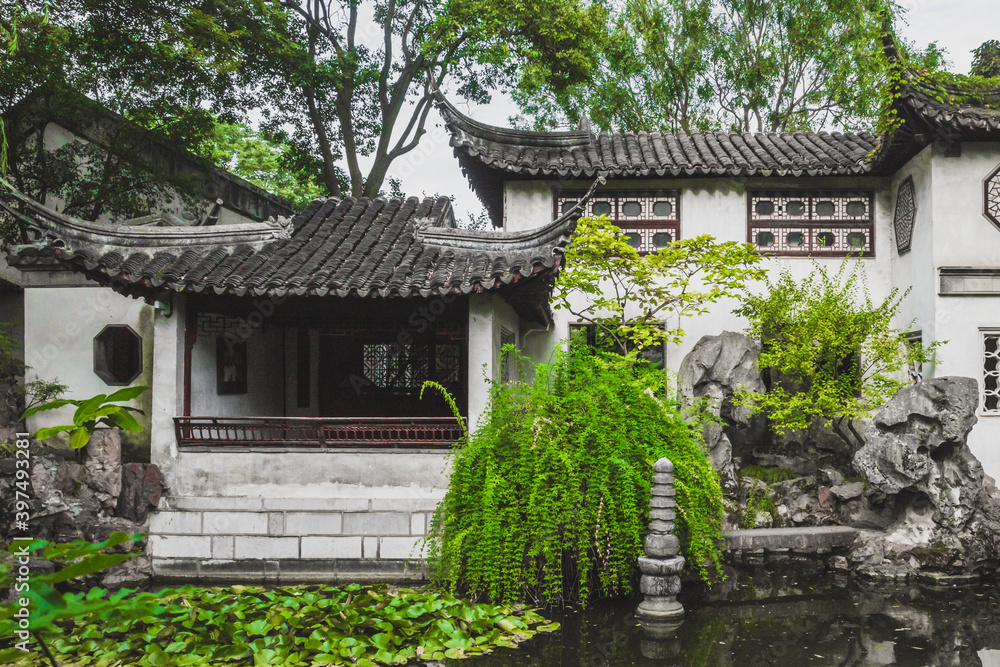 Traditional Chinese architecture by pond at Lingering Garden Scenic Area, Suzhou, Jiangsu, China Traditional Chinese architecture by pond at Lingering Garden Scenic Area, Suzhou, Jiangsu, China