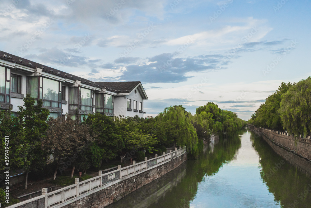Houses and trees along canal Suzhou, Jiangsu, China Houses and trees along canal Suzhou, Jiangsu, China