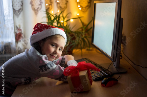 little girl at the computer in the new year