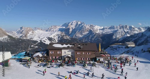 Aerial above ski resort with people partying and dancing in snow at the Ski resorts Dolomites
