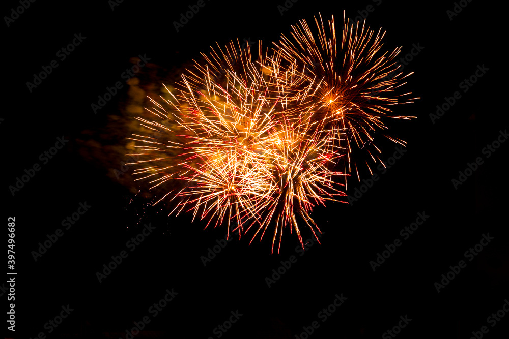 Orange blurred firework lights on black sky background. Concept of New Year and Christmas. Victory salute for Independence Day. Orange blurred firework lights on black sky background. Concept of New Year and Christmas. Victory salute for Independence Day.