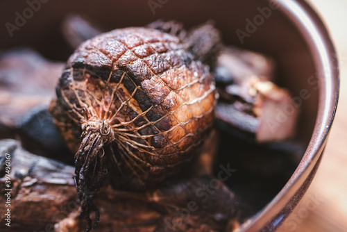 Shallow depth of field shot of pieces of smoked pork in a pot. © Jan Dzacovsky